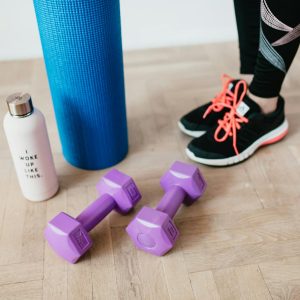 Crop female athlete with sport accessories